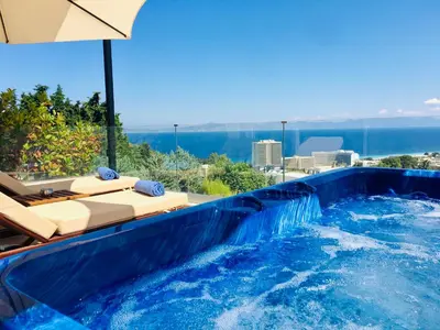 a swimming pool with a water slide at FlyViewFlatsBLUE PrivateHotTub with SeaView in Rhodes Town