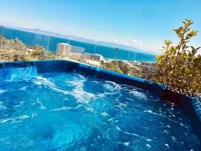 a swimming pool with a view of the ocean at FlyViewFlatsBLUE PrivateHotTub with SeaView in Rhodes Town