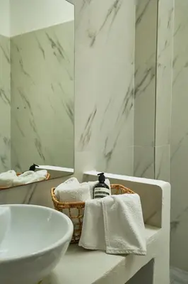 a white bathroom with a sink and a mirror at Mea Terra Villas in Lachania