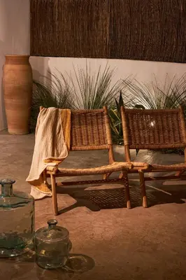 two wicker chairs sitting next to each other at Mea Terra Villas in Lachania