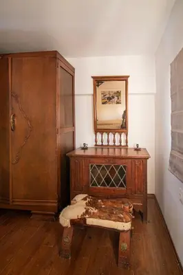 a room with a wooden dresser and a mirror at Nostalgia Suites in Faliraki
