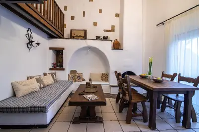 a living room with a couch and a table at Nostalgia Suites in Faliraki