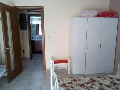 a room with a white cabinet and a chair at Park House -beside the Medieval Town of Rhodes-free parking in Rhodes Town