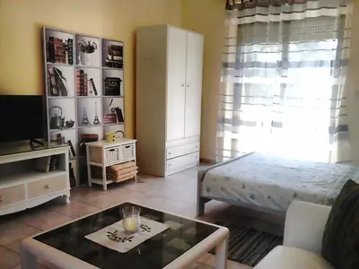 a living room with a bed and a coffee table at Park House -beside the Medieval Town of Rhodes-free parking in Rhodes Town