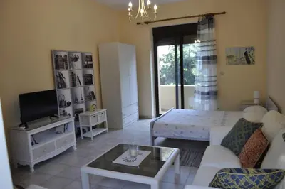 a living room with a couch and a tv at Park House -beside the Medieval Town of Rhodes-free parking in Rhodes Town