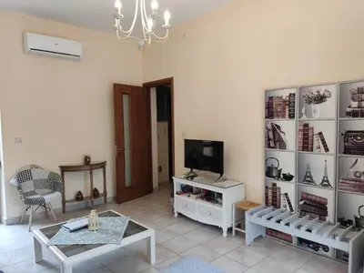 a living room with a tv and a table at Park House -beside the Medieval Town of Rhodes-free parking in Rhodes Town