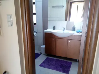 a bathroom with a sink and a mirror at Park House -beside the Medieval Town of Rhodes-free parking in Rhodes Town