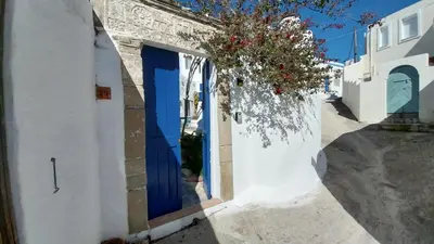 a blue door on the side of a white building at Clive and Bifi's house in Lachania