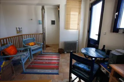 a living room with two chairs and a table at Clive and Bifi's house in Lachania