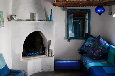 a living room with a couch and a fireplace at Clive and Bifi's house in Lachania