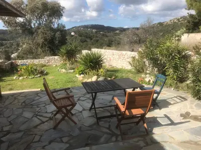 a table and chairs on a patio with a view at Clive and Bifi's house in Lachania