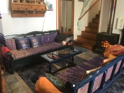 a living room with two couches and a fireplace at Clive and Bifi's house in Lachania