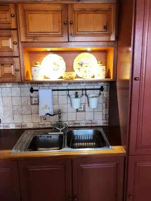 a kitchen sink with plates and dishes on the wall at SeaMe Houses in Symi