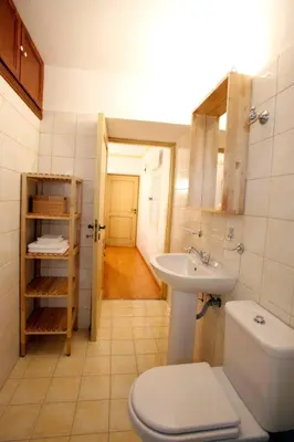 a bathroom with a toilet and a sink at SeaMe Houses in Symi