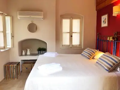 a bedroom with a large white bed in a room at SeaMe Houses in Symi
