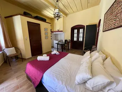 a bedroom with a large white bed in a room at The one & only in Symi