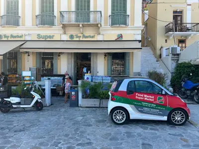 a small car parked in front of a building at The one & only in Symi