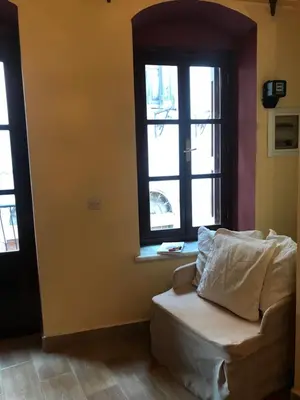 a living room with a couch and a window at The one & only in Symi
