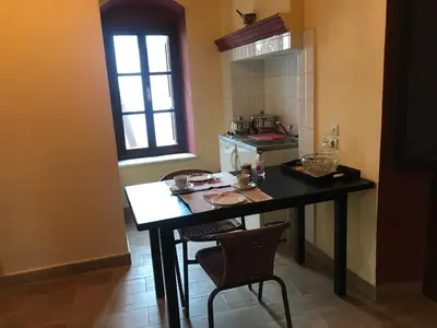 a kitchen with a table and chairs in a room at The one & only in Symi