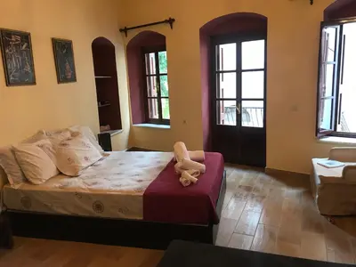 a teddy bear sitting on a bed in a bedroom at The one & only in Symi