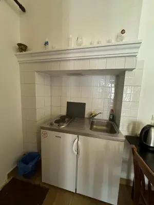 a kitchen with a sink and a counter top at The one & only in Symi
