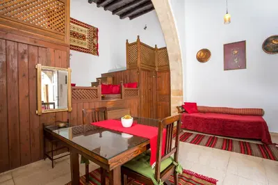 a dining room with a table and a red seat at CasaLindos Festa in Líndos