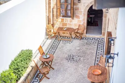 an overhead view of a patio with chairs and a table at CasaLindos Festa in Líndos