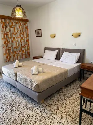 a bedroom with a bed with two towels on it at Sarris Studios & Apartments in Líndos