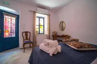 a bedroom with a bed with towels on it at Mascot Garden Rooms in Rhodes Town