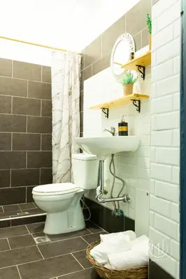 a bathroom with a toilet and a sink at Mascot Garden Rooms in Rhodes Town