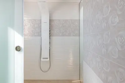 a shower with a shower head in a bathroom at Villa Kivotos in Lardos