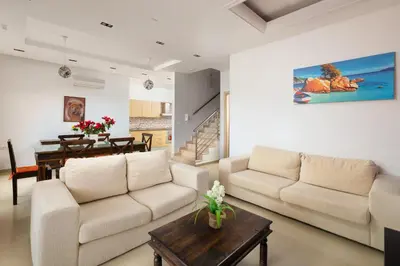 a living room with two couches and a table at Villa Kivotos in Lardos