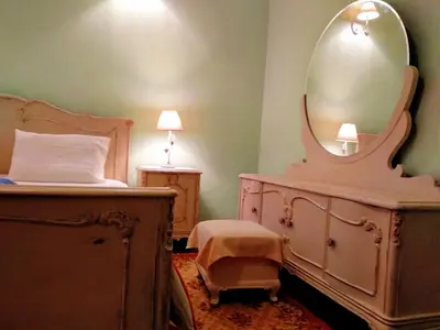 a bedroom with a bed with a dresser and a mirror at Romantic rooms with stunning sea view in Rhodes Town