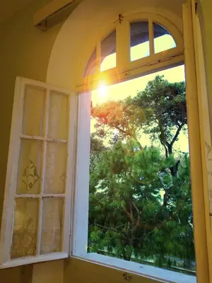 an open window with a view of a tree at Romantic rooms with stunning sea view in Rhodes Town