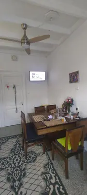 a dining room table with two chairs and a ceiling fan at Romantic rooms with stunning sea view in Rhodes Town
