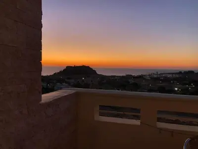 a view of the sunset from the balcony of a house at LINDOS HORIZON in Líndos