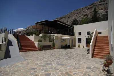 a large building with stairs and a mountain at LINDOS HORIZON in Líndos