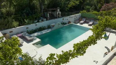 an overhead view of a swimming pool with two lounge chairs at Oliveyard Stone Built House- with pool non chlorin in Koskinou