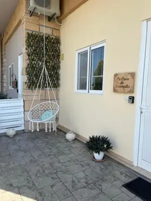 a swing hanging from a building with a patio at La Casa de Tsampika in Koskinou