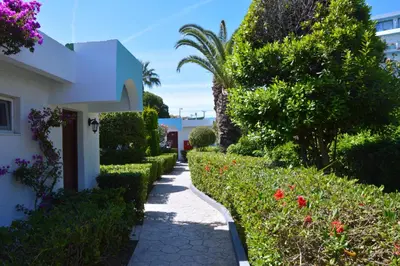 a walkway through a garden next to a house at Blue Horizon in Ialyssos