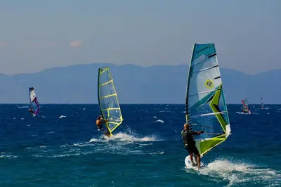 a group of people windsurfing in the ocean at Blue Horizon in Ialyssos