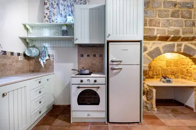 a kitchen with a refrigerator and an oven at A33 Rhodes Old Town House in Rhodes Town