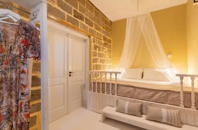 a bedroom with a bed in a brick wall at A33 Rhodes Old Town House in Rhodes Town
