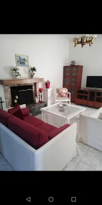 a living room with a couch and a fireplace at Villa Anastasia in Gennadi