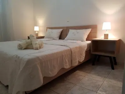 a bedroom with a large bed with two stuffed animals on it at Villa Anastasia in Gennadi