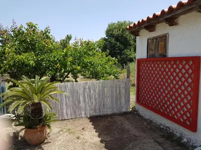 a house with a red gate next to a fence at Villa Anastasia in Gennadi