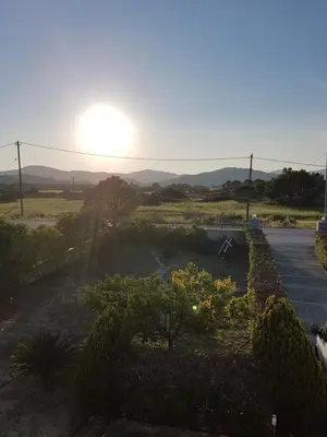 a sunset over a field with a parking lot at Villa Anastasia in Gennadi
