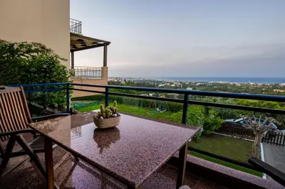 a table with a bowl of bananas on a balcony at Rhodes Sunrise Maisonette in Koskinou