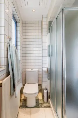 a bathroom with a toilet and a shower at Rhodes Sunrise Maisonette in Koskinou