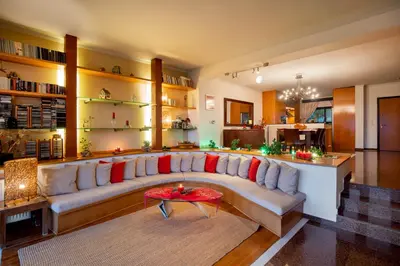 a living room with a couch and a table at Rhodes Sunrise Maisonette in Koskinou